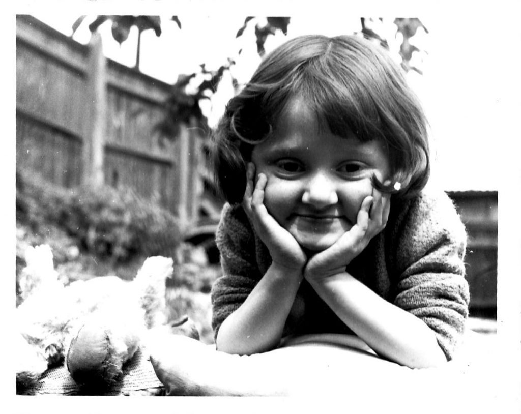 Micheline Mason (ALLFIE's former CEO) as a small child, smiling at the camera