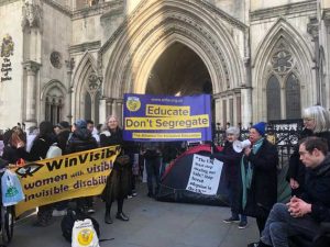 Protestors outside the High Court holding up an ALLFIE banner saying "Educate Don't Segregate", with other protestors holding up a banner saying "WinVisible, Women with visible and invisible disabilities"