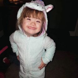 Ava in a bunny suit grinning