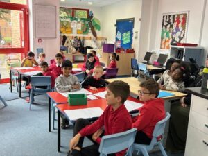 Lesson In the classroom at Mount Stuart Primary School, showing pupils sat at their desks.